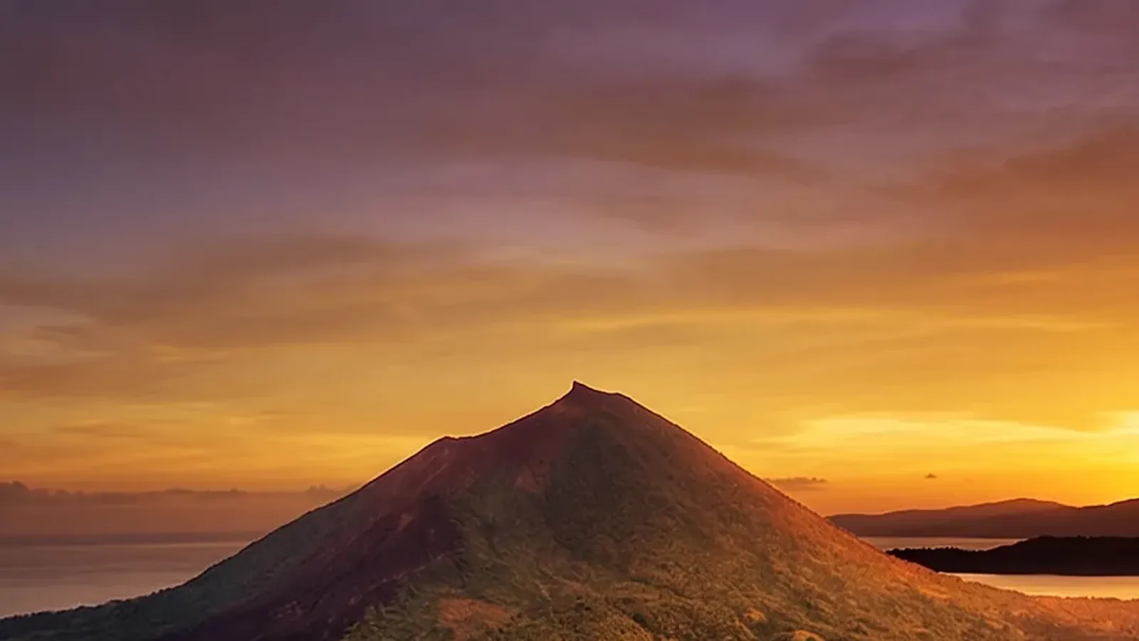 Expedition yacht crossing open Indonesian waters at dusk